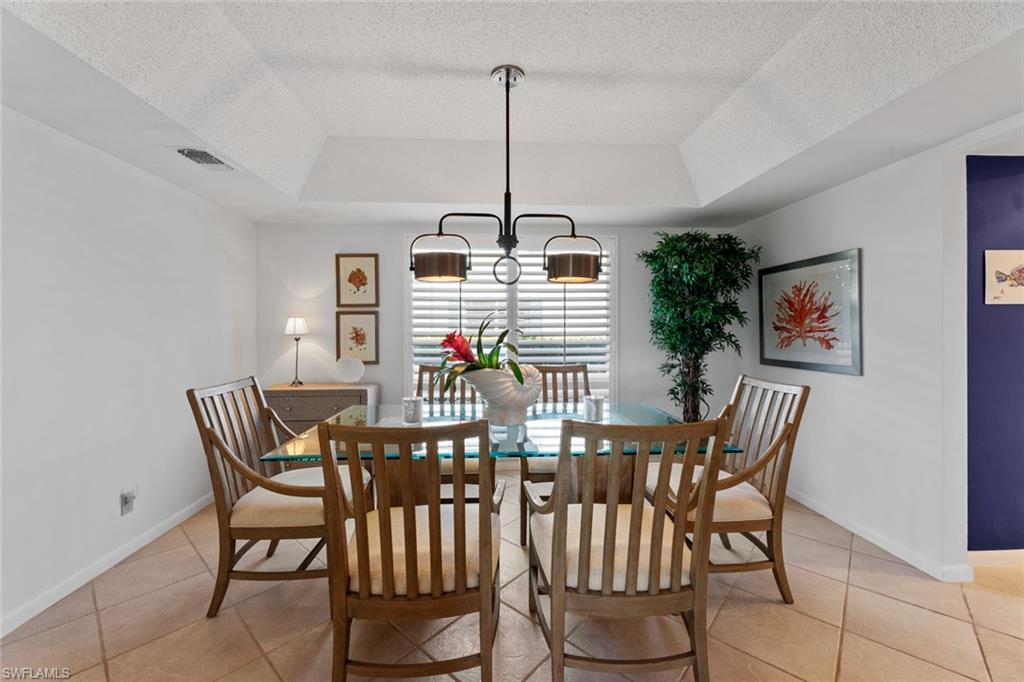 263 Candycane Lane, Unit 7 Naples, FL 34112 - Photo 18 of 50 a view of a dining room with furniture