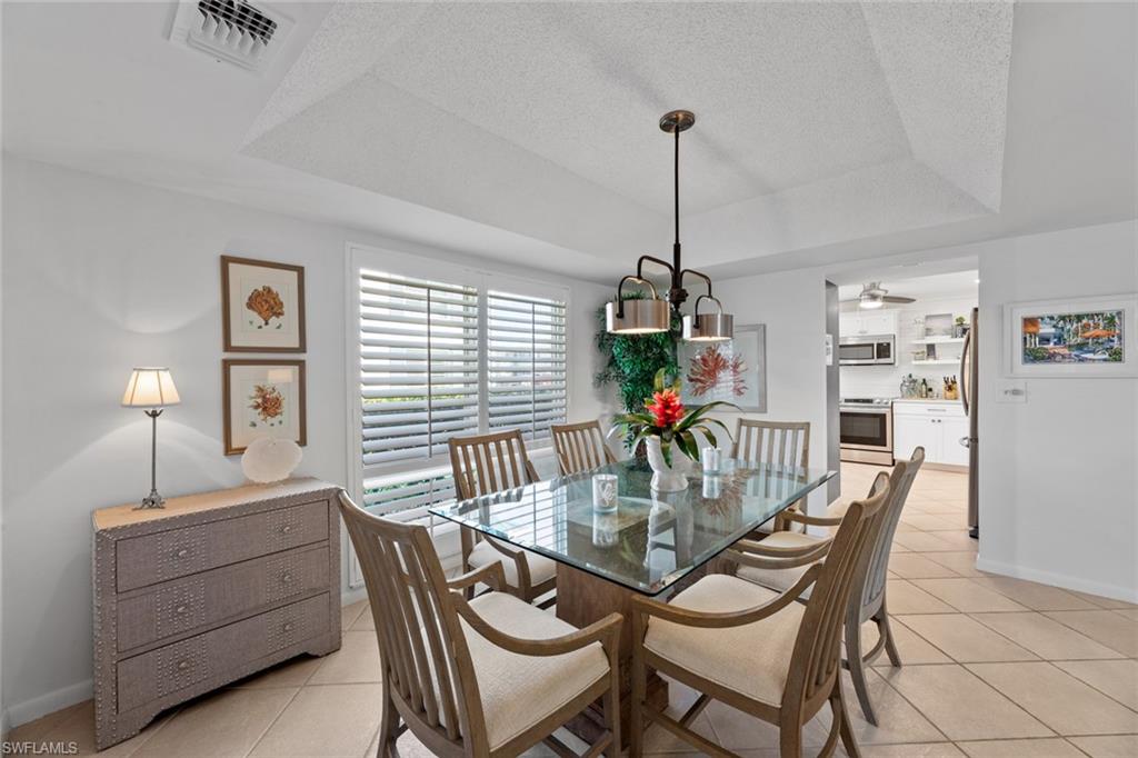 263 Candycane Lane, Unit 7 Naples, FL 34112 - Photo 19 of 50 a dining room with furniture and window