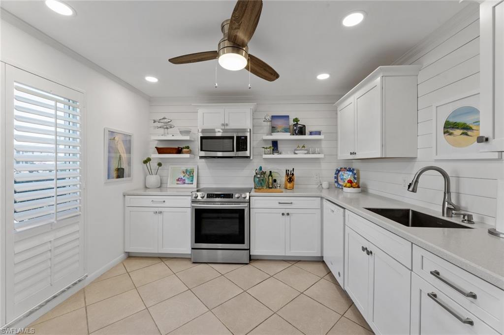 263 Candycane Lane, Unit 7 Naples, FL 34112 - Photo 20 of 50 a kitchen with stainless steel appliances granite countertop a sink a stove a refrigerator cabinets and a window