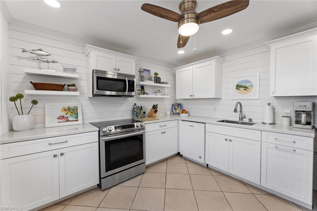 263 Candycane Lane, Unit 7 Naples, FL 34112 - Photo 21 of 50 a kitchen with cabinets stainless steel appliances and a sink