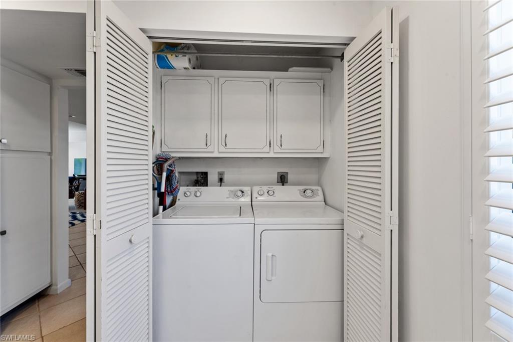 263 Candycane Lane, Unit 7 Naples, FL 34112 - Photo 22 of 50 a utility room with dryer and washer