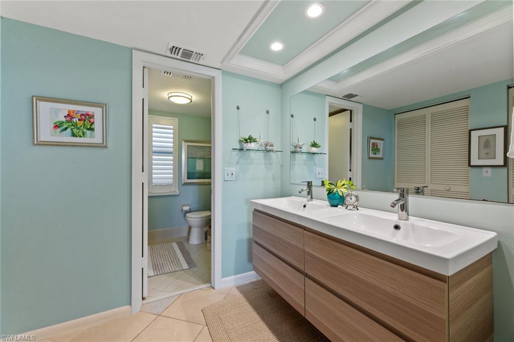 263 Candycane Lane, Unit 7 Naples, FL 34112 - Photo 23 of 50 a bathroom with a sink a toilet and shower