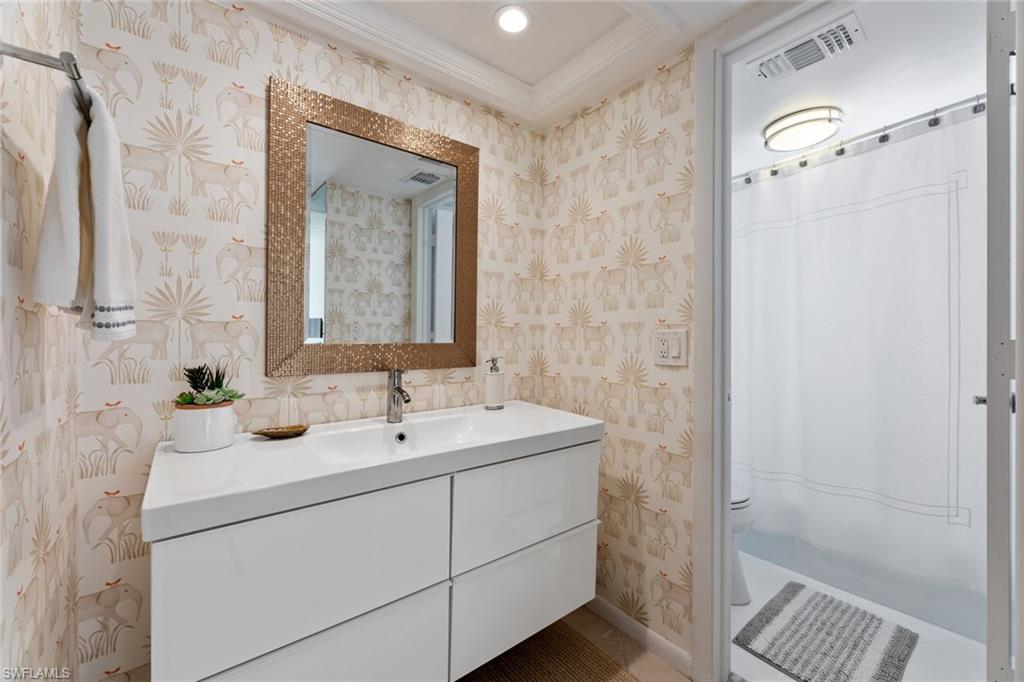 263 Candycane Lane, Unit 7 Naples, FL 34112 - Photo 28 of 50 a bathroom with a sink and a mirror