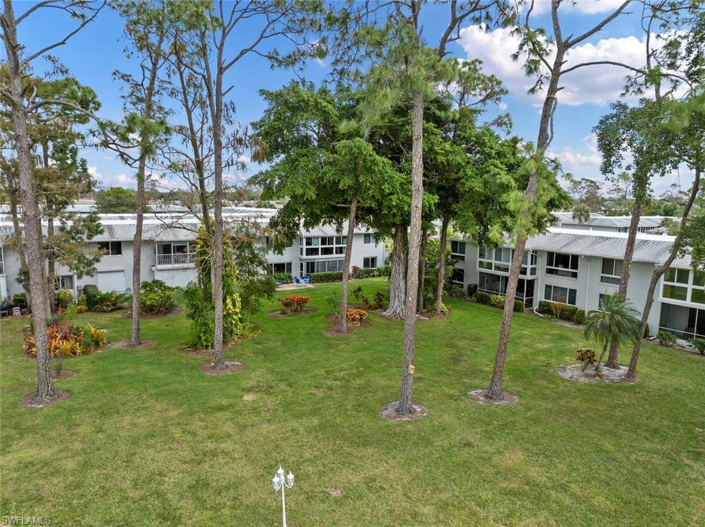 263 Candycane Lane, Unit 7 Naples, FL 34112 - Photo 33 of 50 a view of house with a backyard