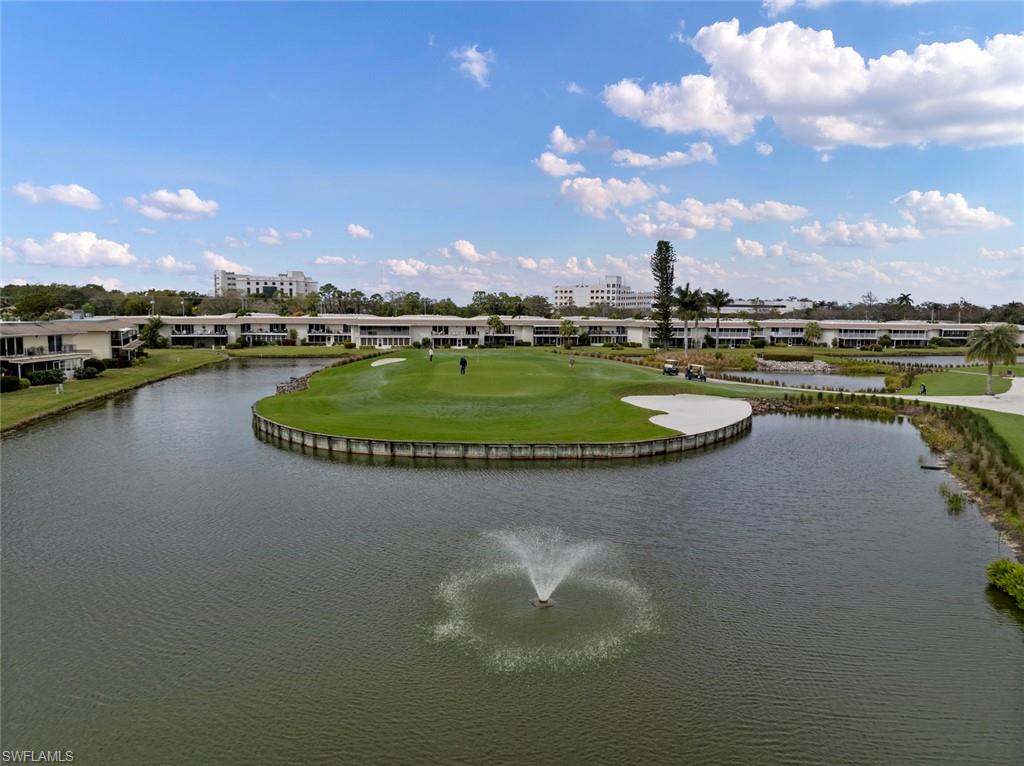 263 Candycane Lane, Unit 7 Naples, FL 34112 - Photo 35 of 50 a view of a lake with a yard
