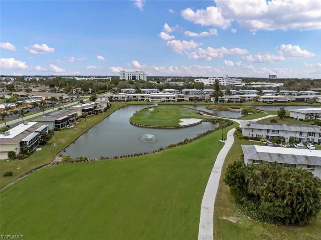 263 Candycane Lane, Unit 7 Naples, FL 34112 - Photo 36 of 50 a view of a lake with a house