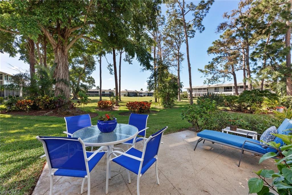 263 Candycane Lane, Unit 7 Naples, FL 34112 - Photo 8 of 50 a view of a chairs and table in the yard