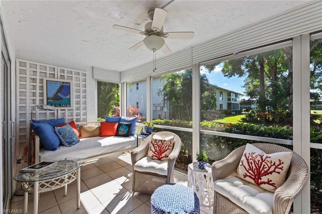 263 Candycane Lane, Unit 7 Naples, FL 34112 - Photo 10 of 50 a living room with fireplace furniture and a large window