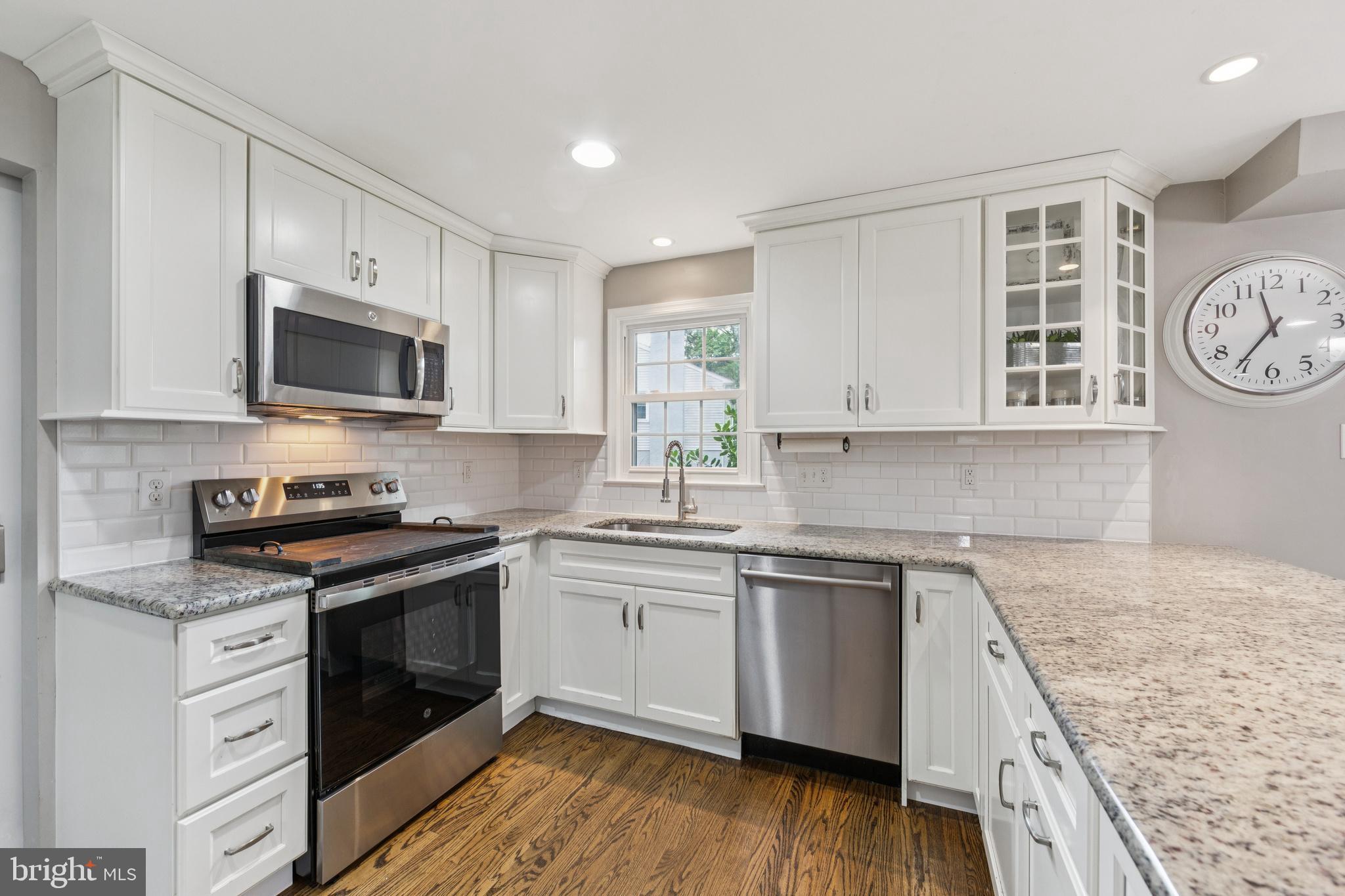 15 Oakford Road Wayne, PA 19087 - Photo 11 of 54 a kitchen with granite countertop a stove top oven sink and cabinets