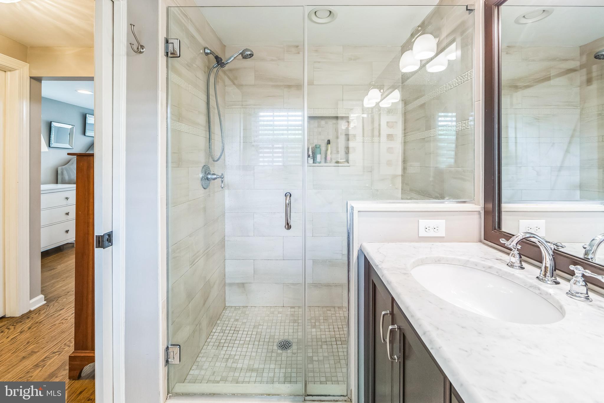 15 Oakford Road Wayne, PA 19087 - Photo 27 of 54 a bathroom with a granite countertop sink a mirror and shower