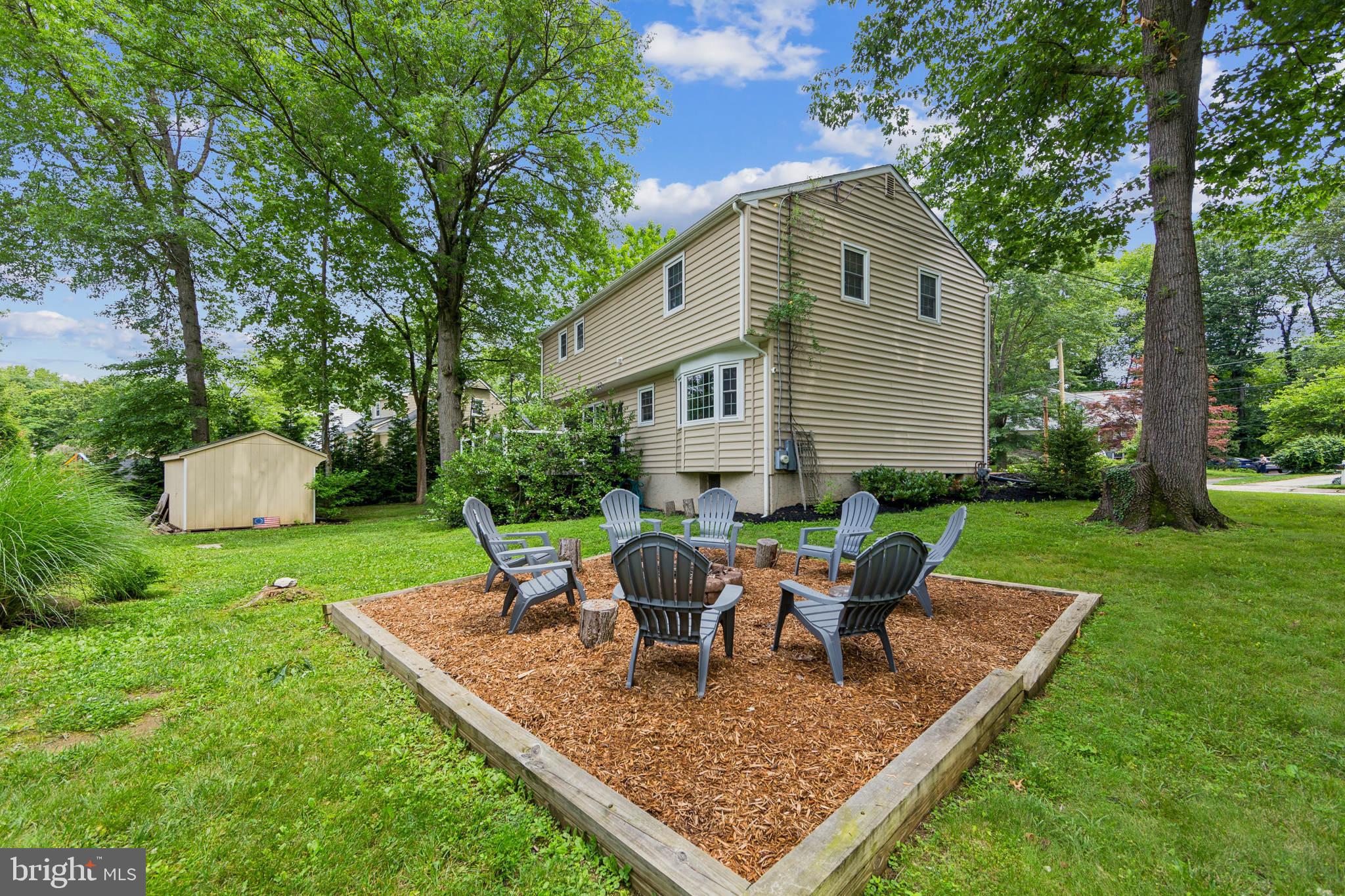 15 Oakford Road Wayne, PA 19087 - Photo 41 of 54 a view of a backyard with table and chairs potted plants and large tree
