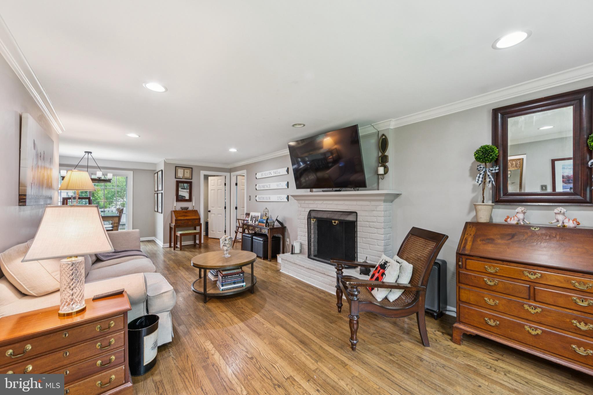 15 Oakford Road Wayne, PA 19087 - Photo 6 of 54 a living room with furniture a flat screen tv and a fireplace