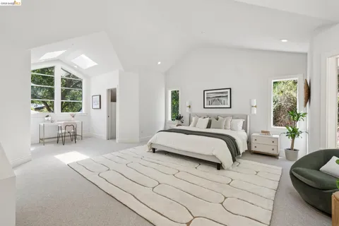 a bedroom with two beds and a large window