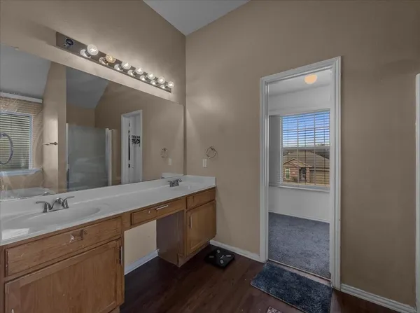 a spacious bathroom with a double vanity sink and a mirror