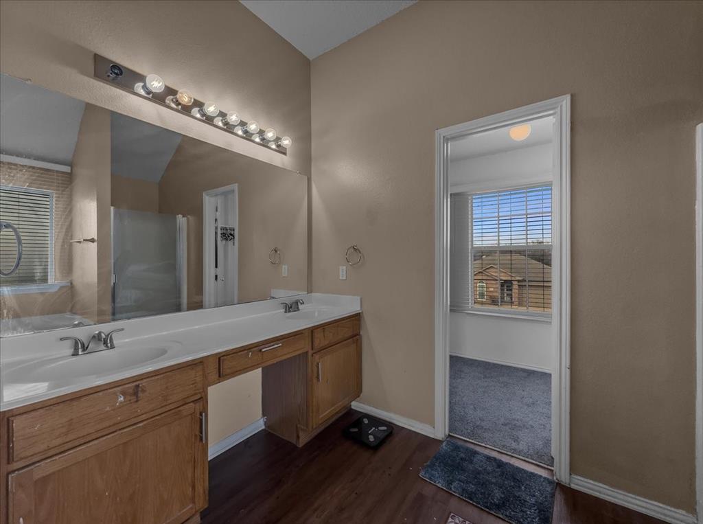 1119 Gaines Mills Road Grand Prairie, TX 75052 - Photo 12 of 29 a spacious bathroom with a double vanity sink and a mirror