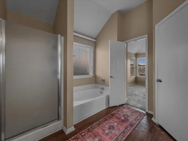 a bathroom with a tub and shower