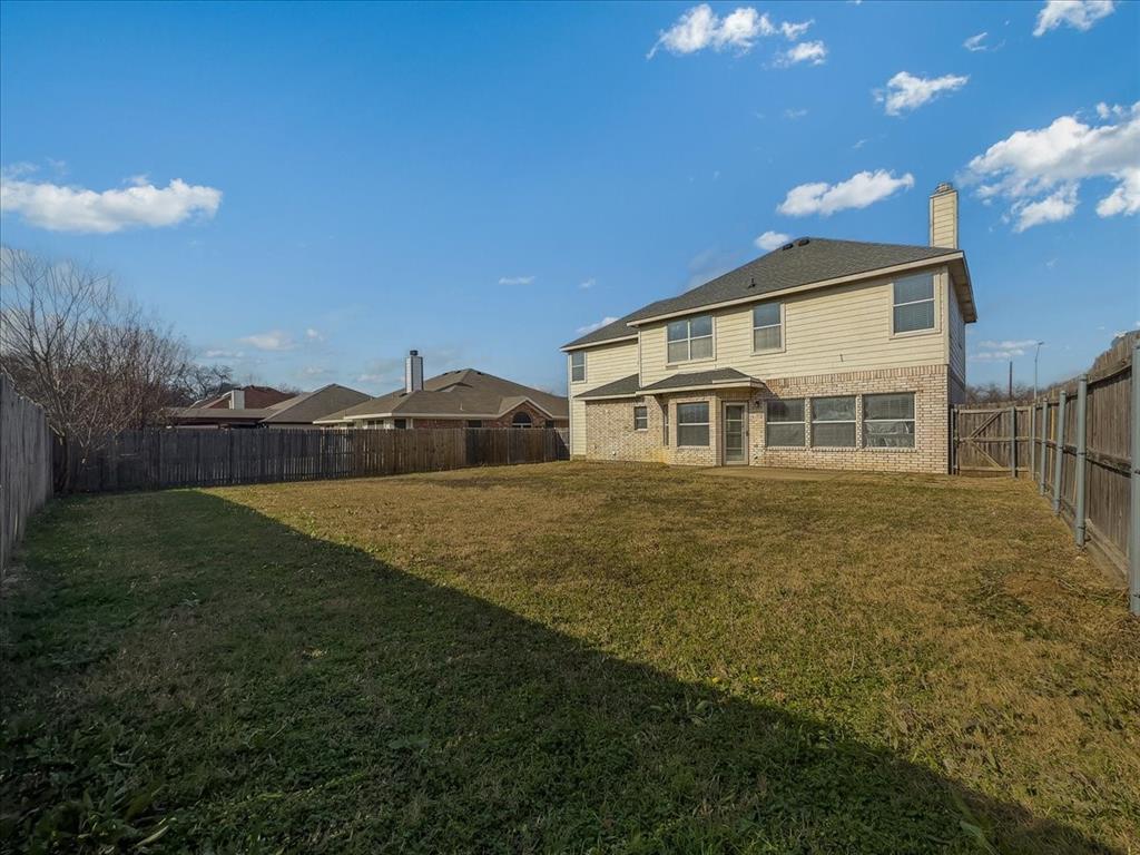 1119 Gaines Mills Road Grand Prairie, TX 75052 - Photo 18 of 29 a front view of a house with a garden
