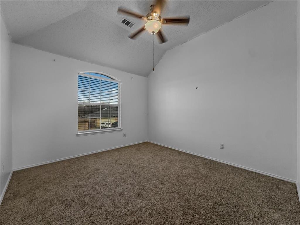 1119 Gaines Mills Road Grand Prairie, TX 75052 - Photo 2 of 29 an empty room with a window and ceiling fan