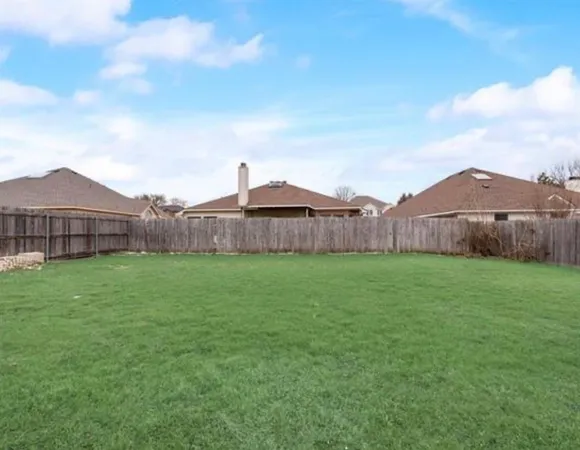 a view of a backyard with table and chairs