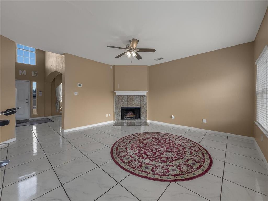 1119 Gaines Mills Road Grand Prairie, TX 75052 - Photo 4 of 29 a view of a room with a fireplace and chandelier fan