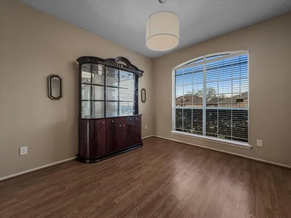 a view of a livingroom with wooden floor and a large window