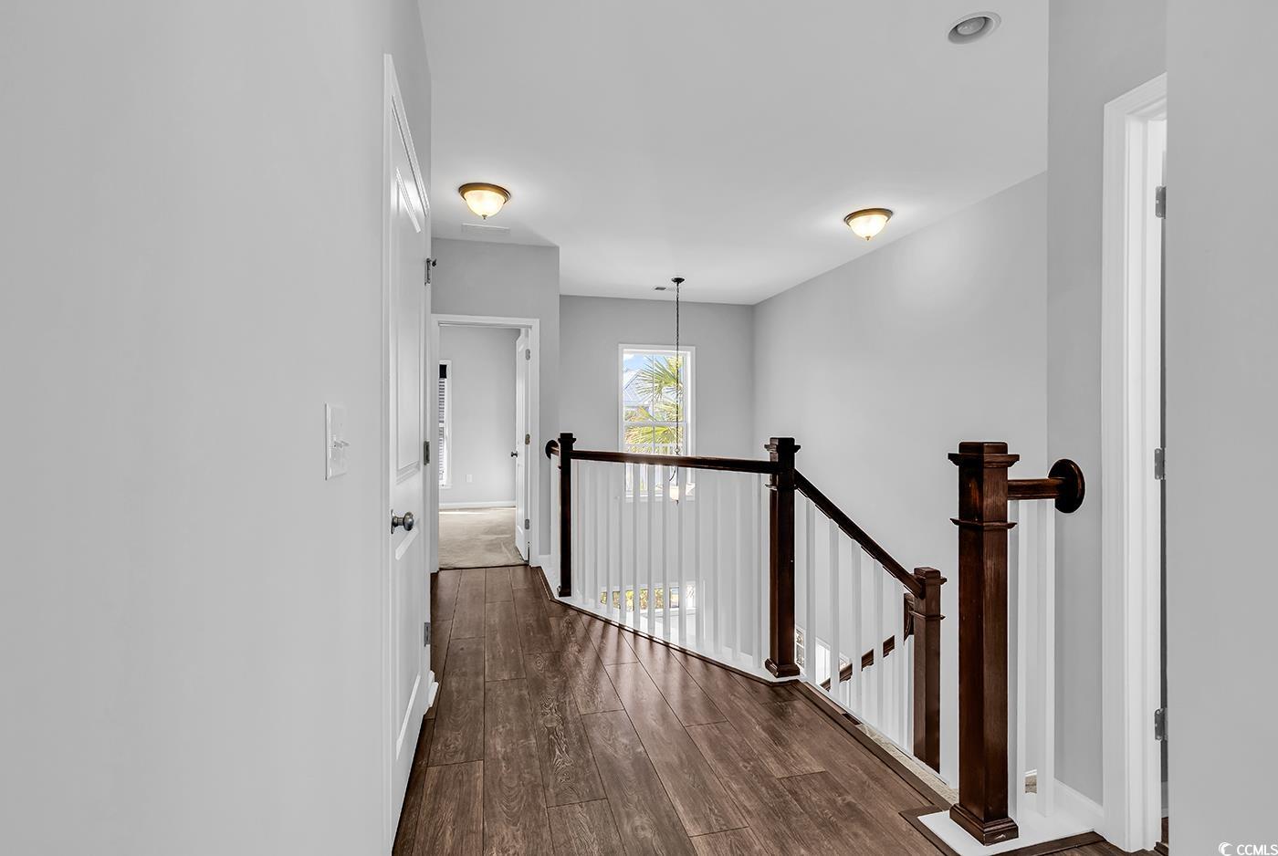 161 Splendor Circle Murrells Inlet, SC 29576 - Photo 12 of 37 Corridor featuring an upstairs landing and dark wood-type flooring