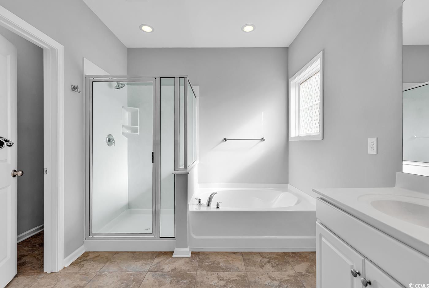 161 Splendor Circle Murrells Inlet, SC 29576 - Photo 18 of 37 Full bathroom featuring a stall shower, double vanity, a garden tub, light tile patterned flooring, and recessed lighting