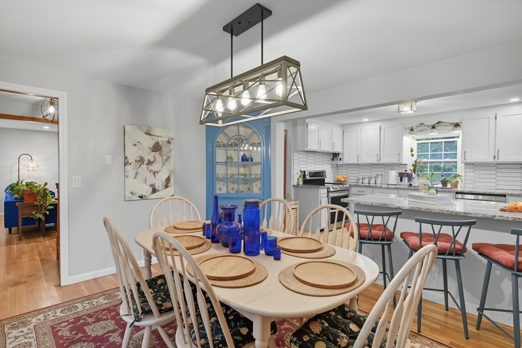 551 West Street Amherst, MA 01002 - Photo 13 of 39 a view of a dining room with furniture a kitchen and chandelier