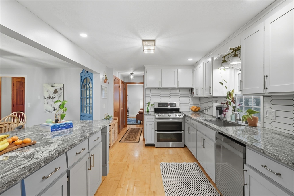 551 West Street Amherst, MA 01002 - Photo 8 of 39 a kitchen with stainless steel appliances granite countertop a sink stove refrigerator and cabinets