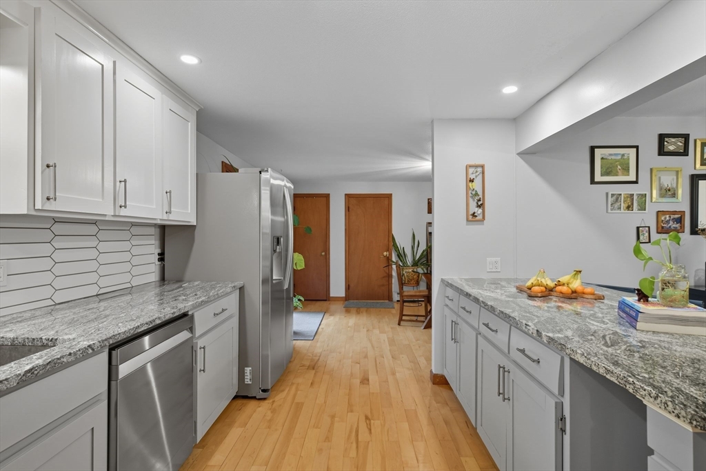 551 West Street Amherst, MA 01002 - Photo 9 of 39 a kitchen with stainless steel appliances granite countertop a sink stove and refrigerator