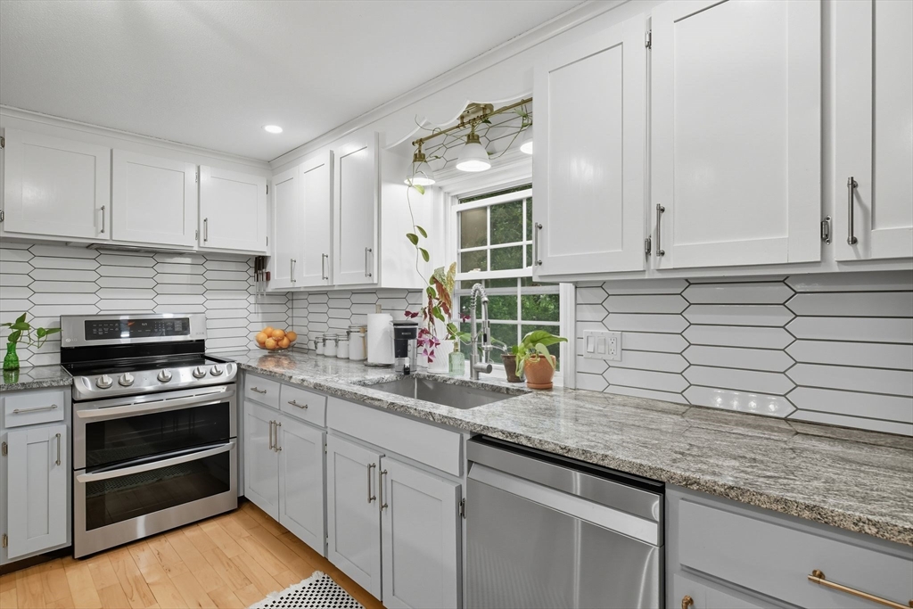 551 West Street Amherst, MA 01002 - Photo 10 of 39 a kitchen with granite countertop a sink stainless steel appliances and cabinets