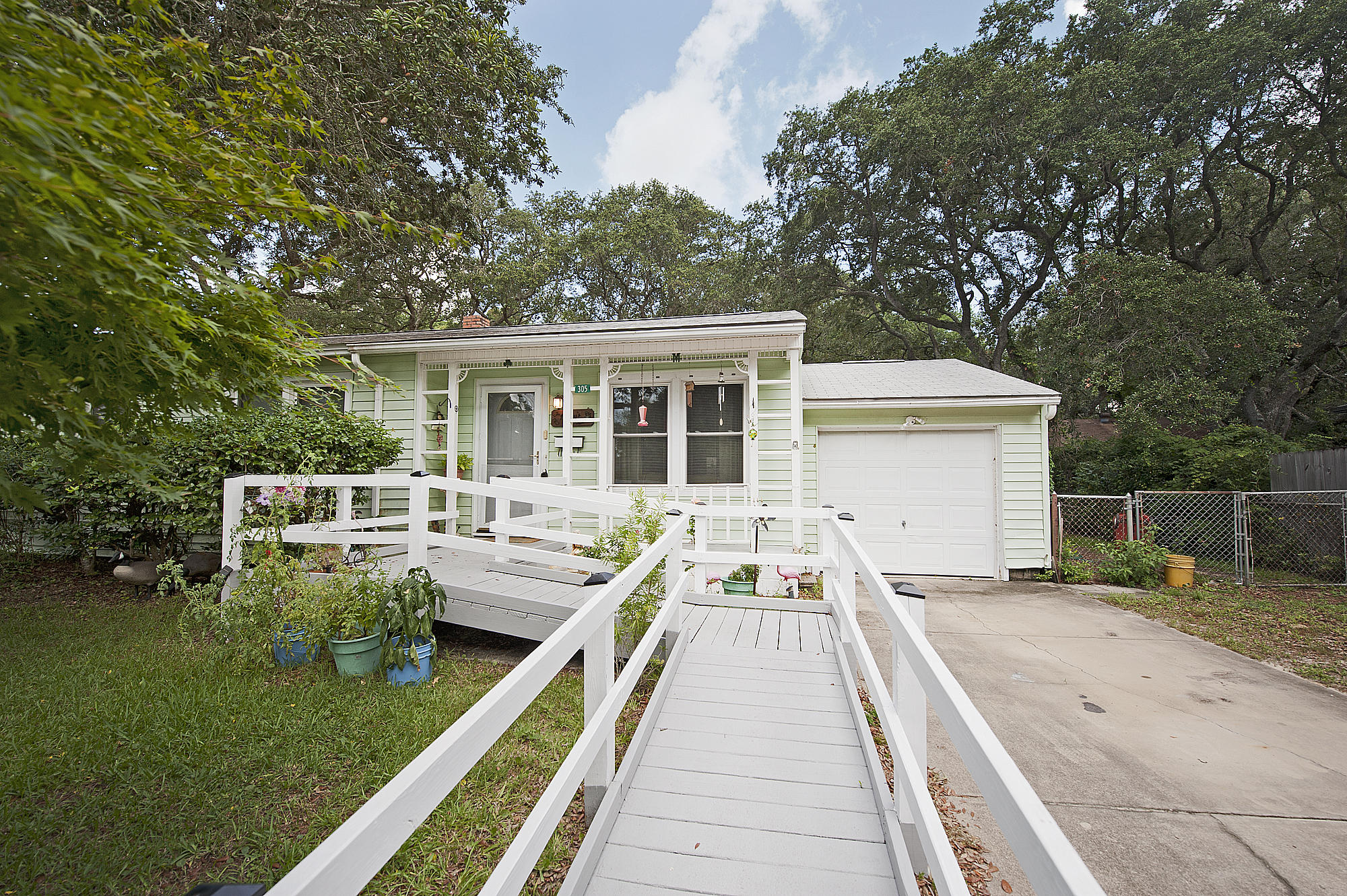 305 Okaloosa Road Northeast Fort Walton Beach, FL 32548 - Photo 2 of 26 a view of a house with backyard sitting area and garden