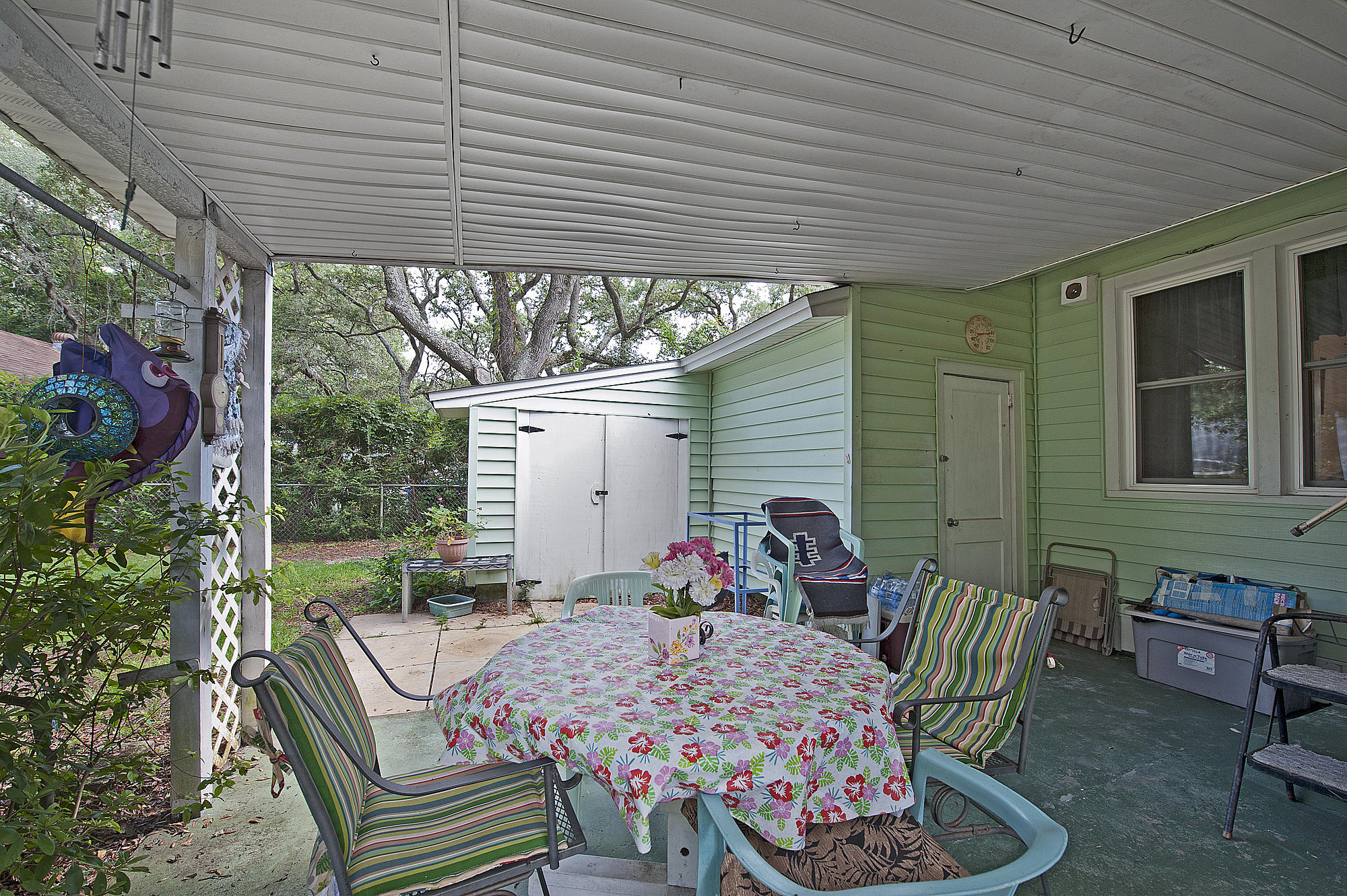 305 Okaloosa Road Northeast Fort Walton Beach, FL 32548 - Photo 24 of 26 a view of a patio with table and chairs potted plants with wooden floor and seating space