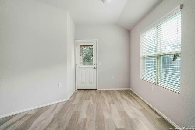 a view of room with window and hardwood floor
