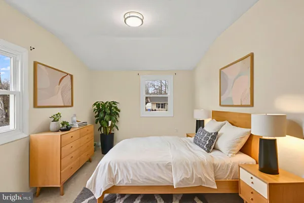 a bedroom with a bed and a couch