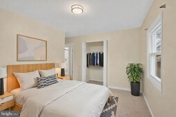 a bedroom with a bed and a potted plant
