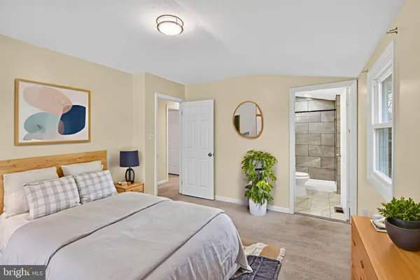 a bedroom with a bed and a potted plant