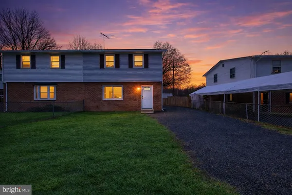 a view of a brick house with a yard