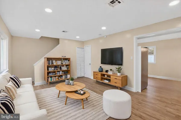 a living room with furniture a flat screen tv and rug