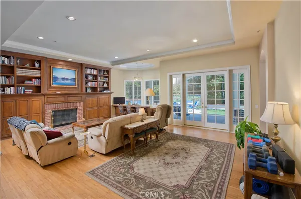 a living room with fireplace furniture and a rug