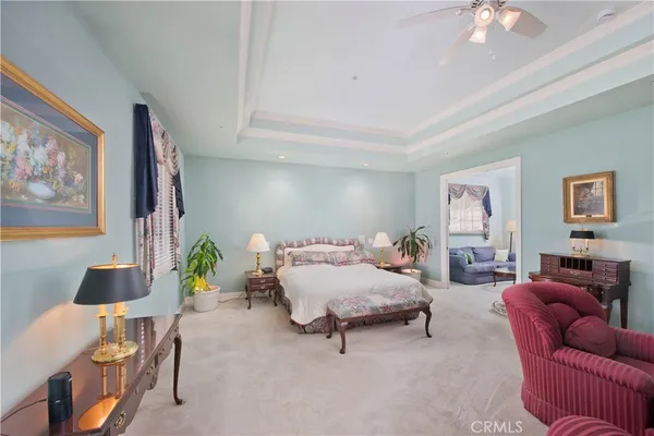 a bedroom with furniture and a chandelier