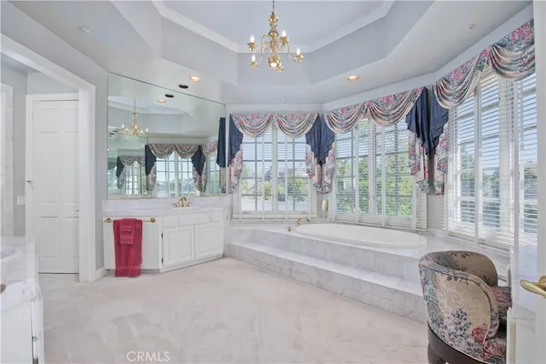 a spacious bathroom with a granite countertop tub and a large window