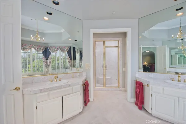 a spacious bathroom with a double vanity sink a mirror and a bathtub