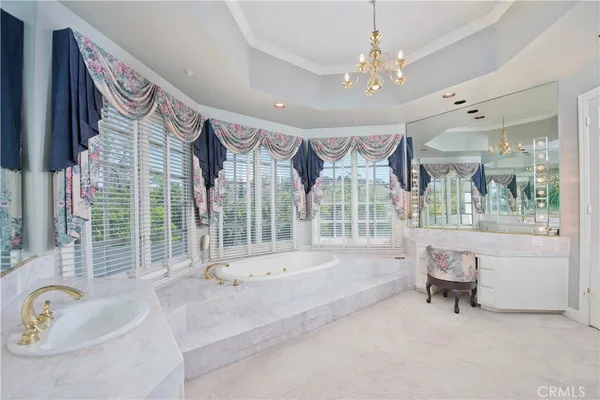 a bathroom with a tub sink and large window