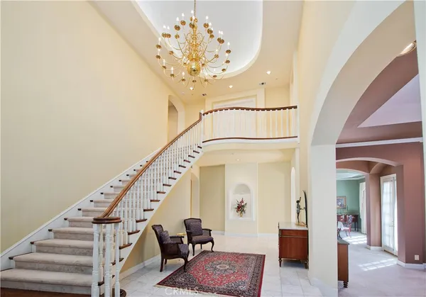 a view of entryway with wooden floor and a chandelier