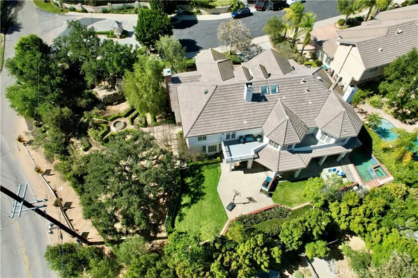 an aerial view of a house with table and chairs