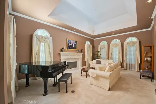 a living room with furniture a fireplace and a large window