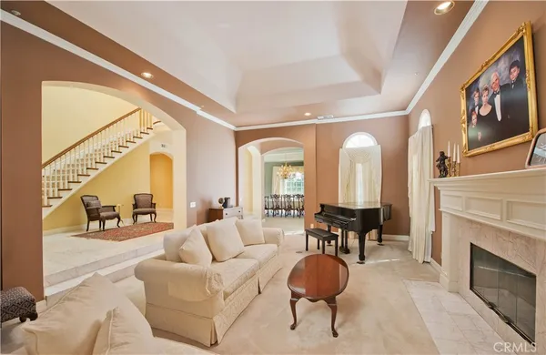 a living room with furniture a fireplace and a large window