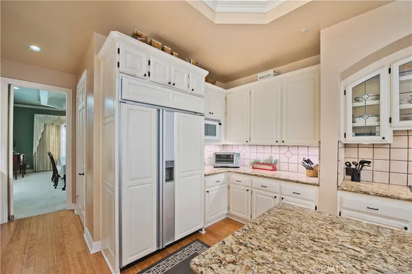 a kitchen with stainless steel appliances sink refrigerator and cabinets