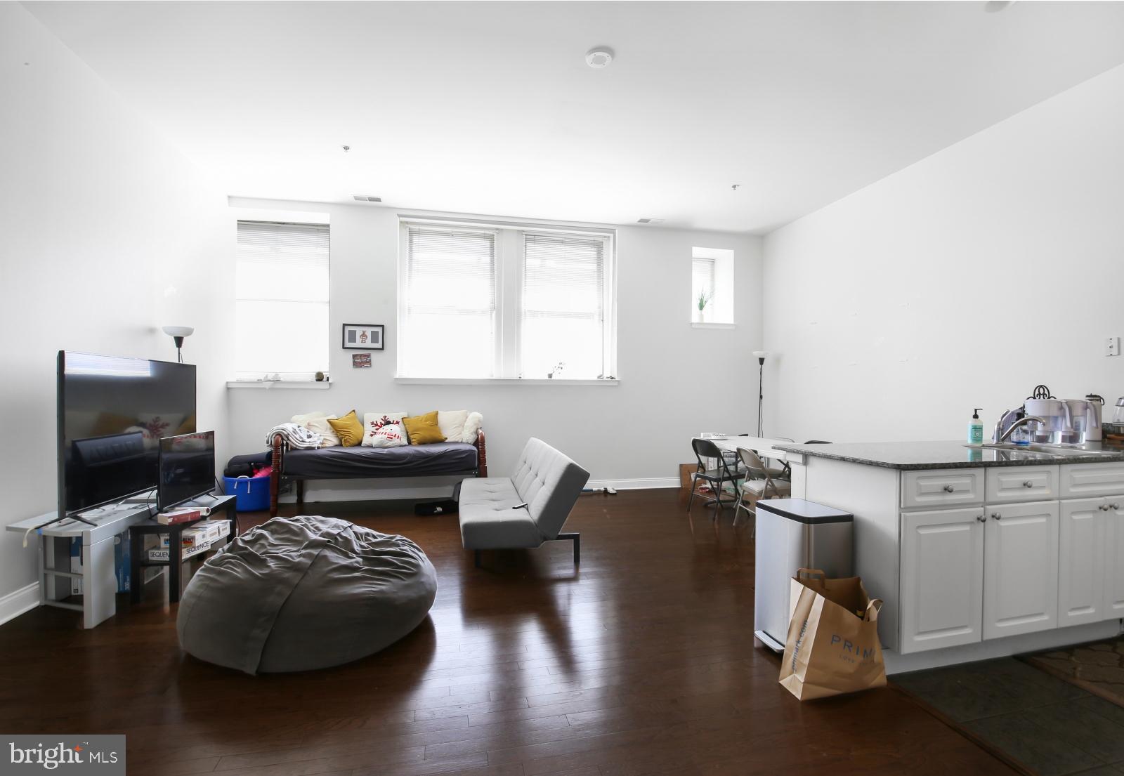 1001 Chestnut Street, Unit 903W Philadelphia, PA 19103 - Photo 2 of 21 a living room with furniture and a flat screen tv